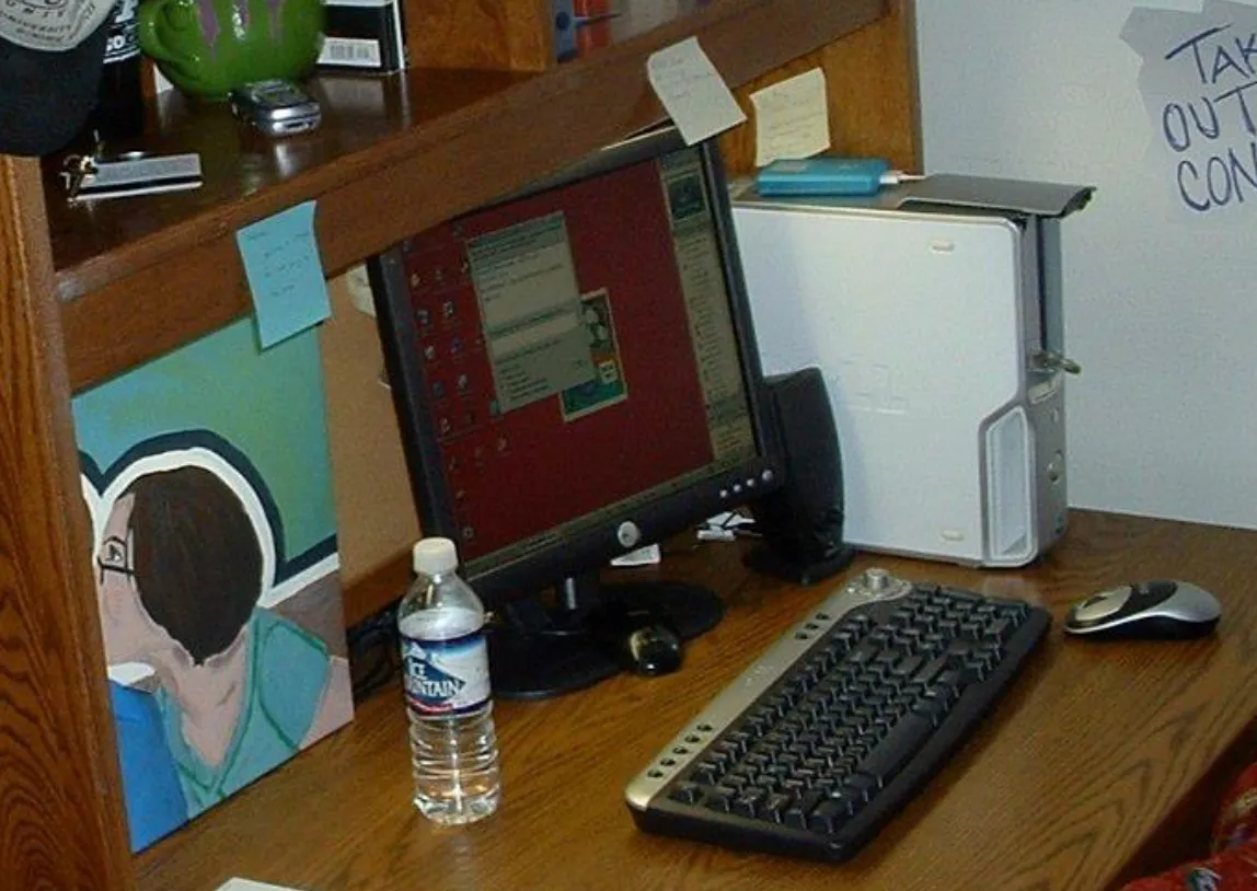Blast from the past, Purdue dorm desk, AIM open, iPod charging, flip phone in the corner, 1