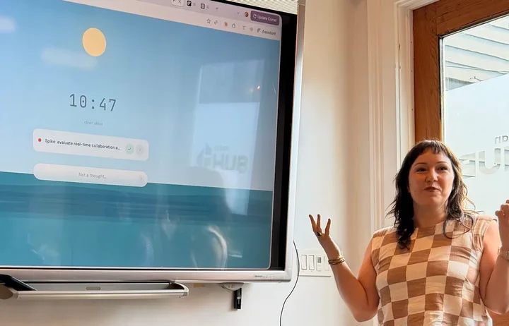 Laura presenting SPF in front of a screen showing the Focus Mode 'clear skies' header at AI Friday, New Orleans.